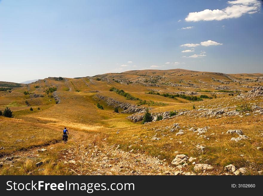 Biker on mountain plateau