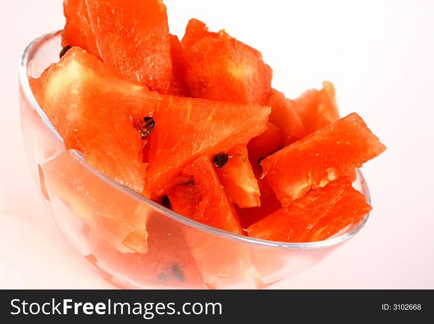 Background of brightly lit red watermelon slices.