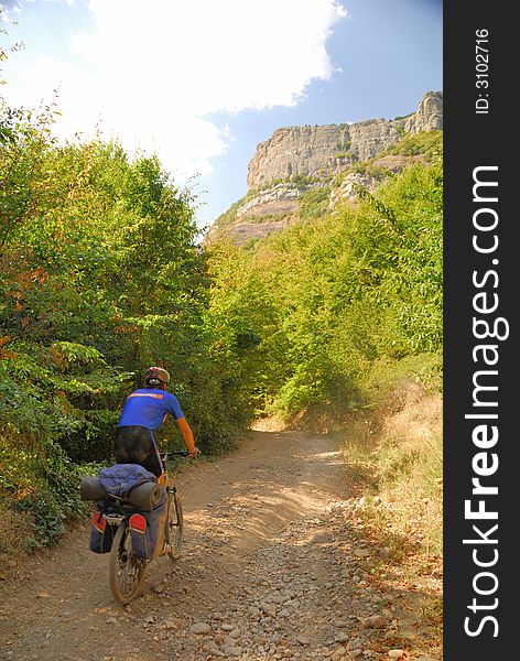 Biker on the mountain road. (Dimerdzhi mountain in Crimea, Ukraine)