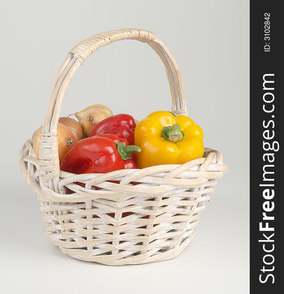 Basket with fresh peppers and onions. Basket with fresh peppers and onions