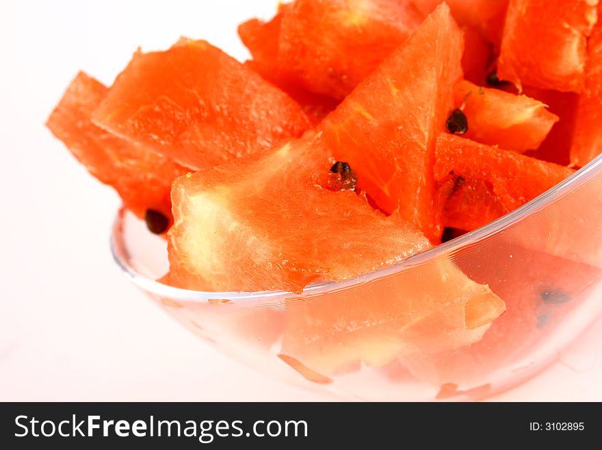 Background of brightly lit red watermelon slices.