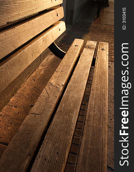 Wooden bench bathed in morning sunlight. Wooden bench bathed in morning sunlight