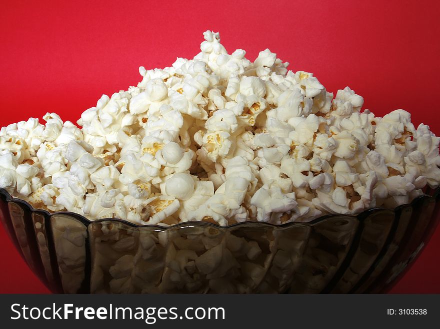 Popcorn bowl isolated on red