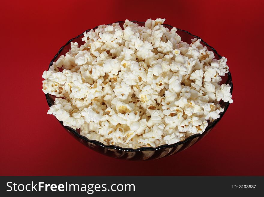 Popcorn bowl isolated on red
