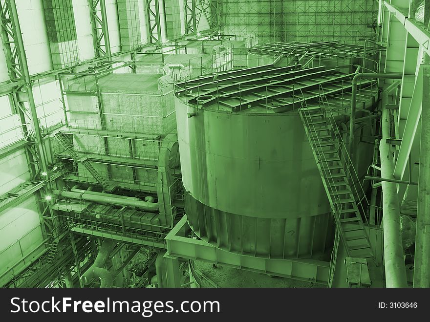 Different types of pipes and tanks inside energy plant