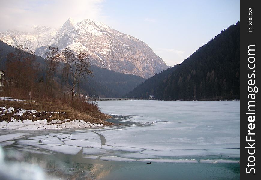 Auronzo lake in winter, with mountains of the cadore like background