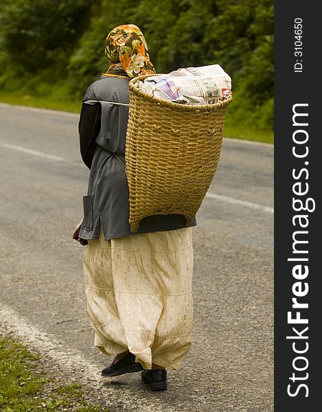 Woman carrier with heavy carriage walking in east Turkey/. Woman carrier with heavy carriage walking in east Turkey/