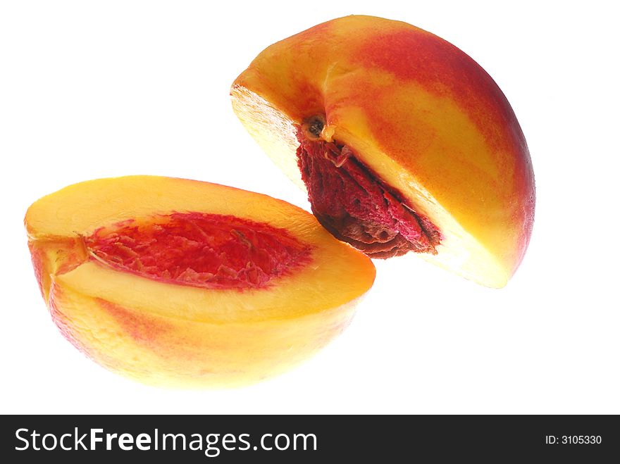 Divided nectarine on white background