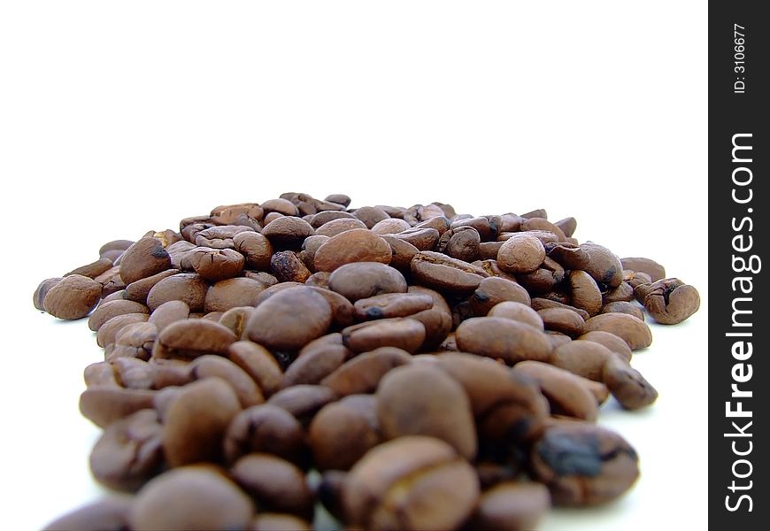 Coffee beans laid out on white background