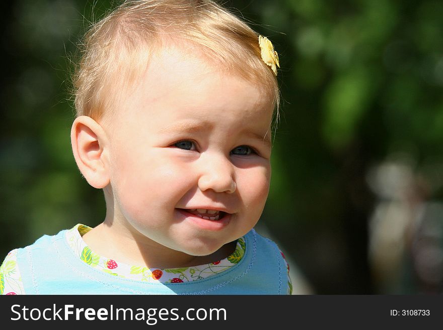 Little smiling girl on the green backstage. Little smiling girl on the green backstage