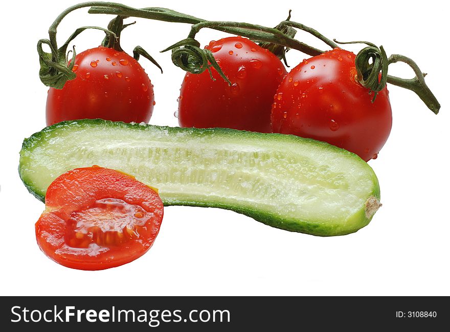 Isolated tomatoes with water drops on them and cucumber slice. Isolated tomatoes with water drops on them and cucumber slice