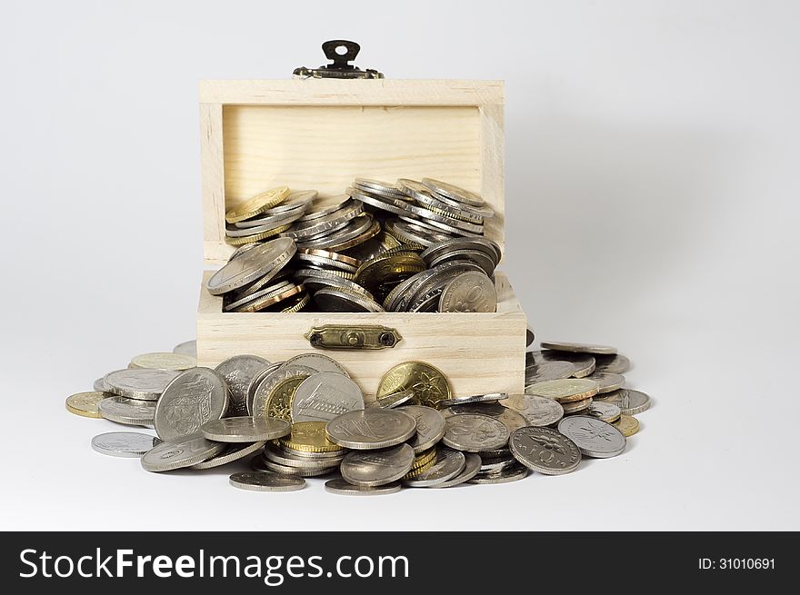 Box with coins on white background