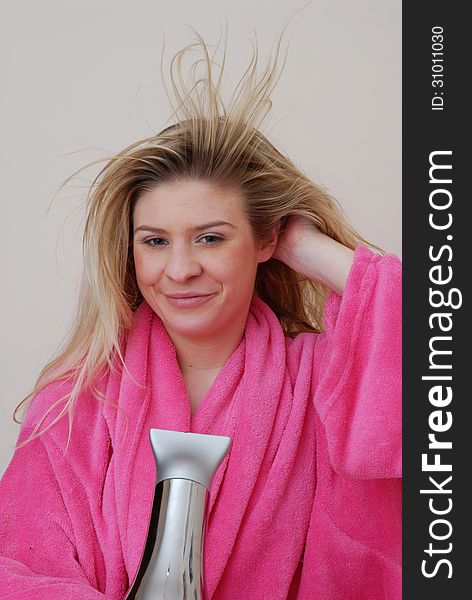 Young woman drying hair after bath. Young woman drying hair after bath.