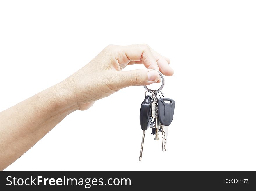 Hand holding car keys over white background