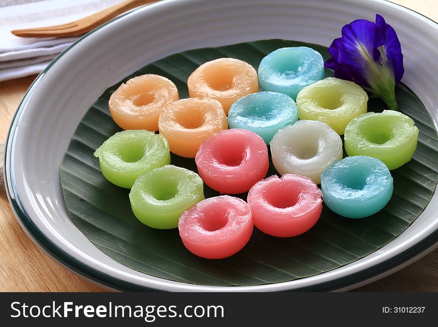 Namdokmai is Thai traditional dessert made from rice and sugar. The colors are extracted from variety of flowers but the smell of jasmine. Presented on a piece of banana leaf. Namdokmai is Thai traditional dessert made from rice and sugar. The colors are extracted from variety of flowers but the smell of jasmine. Presented on a piece of banana leaf.