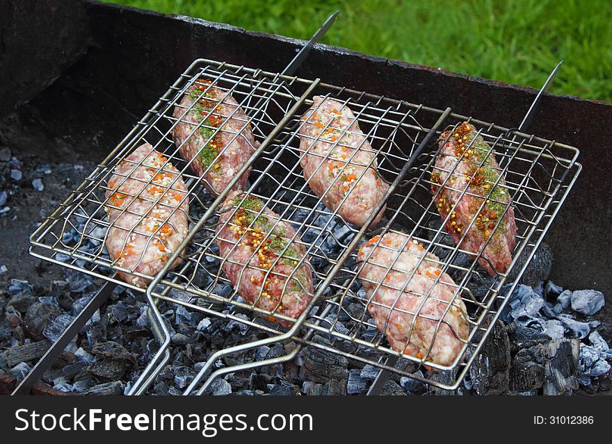 Pork and beef kebab roasting on the grill grid. Pork and beef kebab roasting on the grill grid