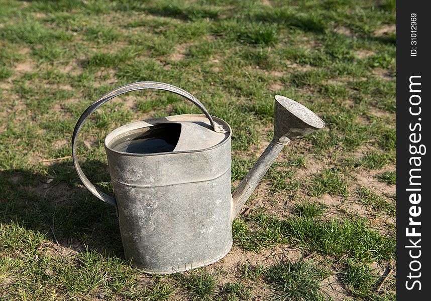 Aged metallic watering pot