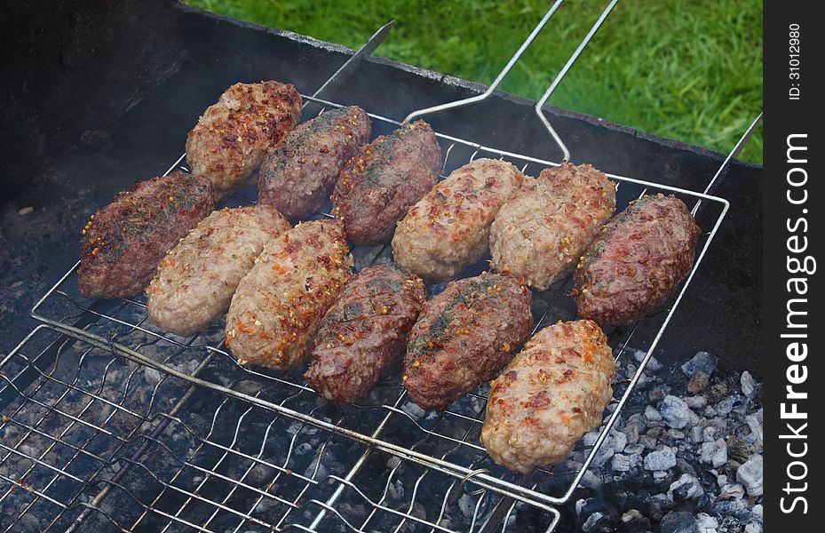 Pork and beef kebab roasting on the grill grid. Pork and beef kebab roasting on the grill grid