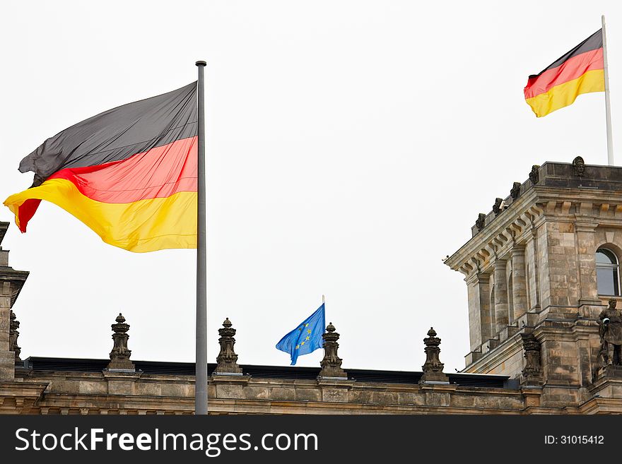 Two big German flags and one small EU flag on the roof of the Reichstag. Two big German flags and one small EU flag on the roof of the Reichstag