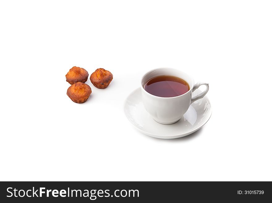 Cup of tea with cupcakes on white background