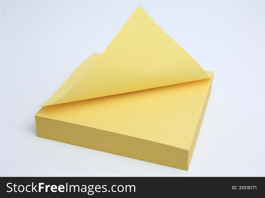 Yellow sticky note isolated on a white background