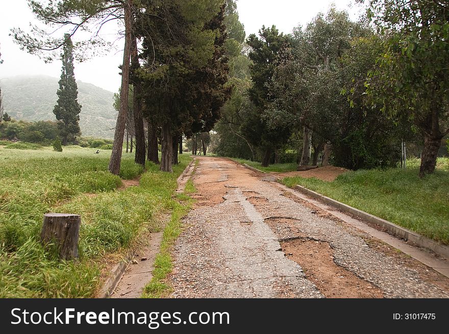 Grunge distressed road leading into misty hills. Grunge distressed road leading into misty hills