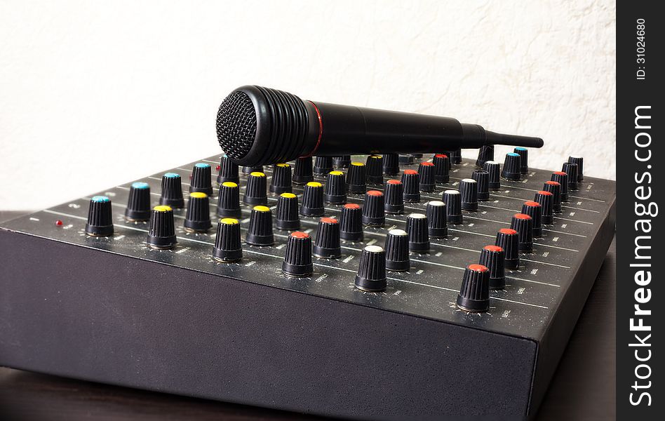 DJ mixer with microphone on white background