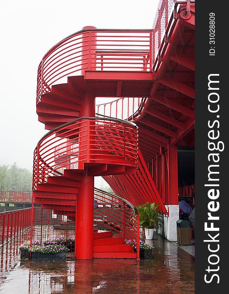 The red color metal spiral stairway.