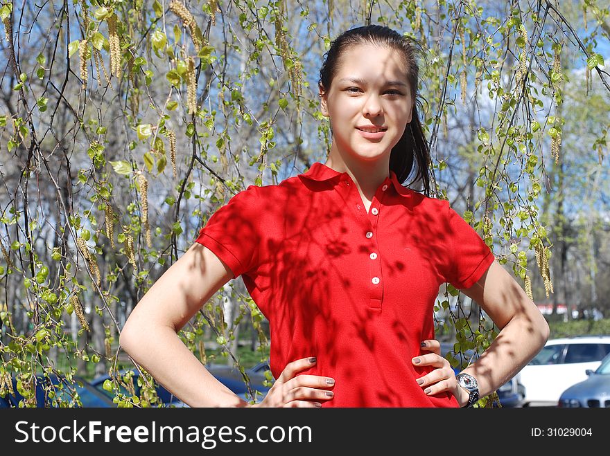 Young beautiful Girl in spring and tree blossom in summer dress