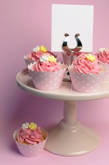 Beautiful Pink Decorated Cupcakes On Pink Cake Stand - Vertical With Blank Sign. Stock Images