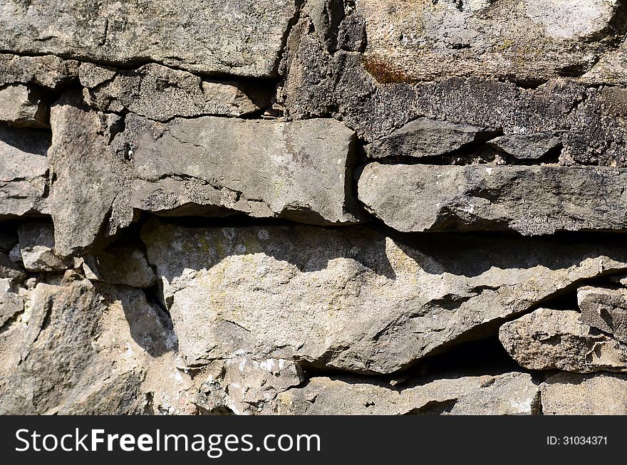 Old Stone wall with shadows and concret