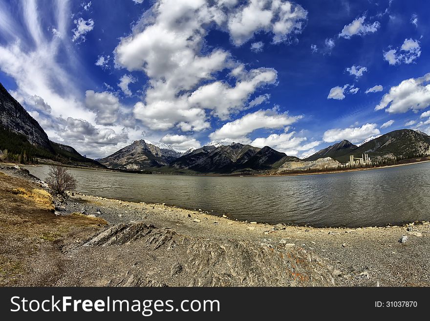 Lac des Arcs with part of the Canadian rocky mountains in the background thru a fisheye lens. Lac des Arcs with part of the Canadian rocky mountains in the background thru a fisheye lens