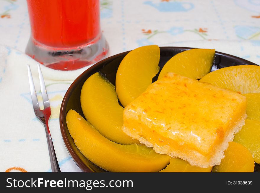 A fresh peach cake with peach segments on plate