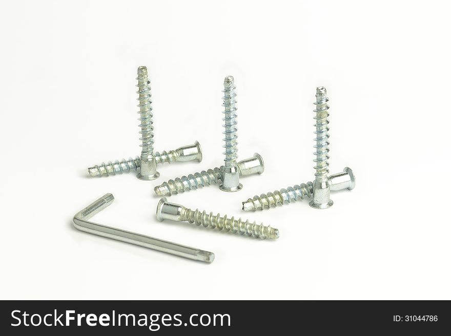 Seven screws and a key to staying in isolated white background. Seven screws and a key to staying in isolated white background.