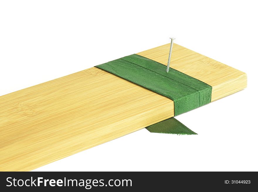 Nail into a board with green ribbon. Nail into a board with green ribbon.