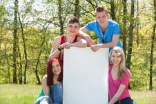 Teenagers Presenting An Empty Copy Space Royalty Free Stock Photo