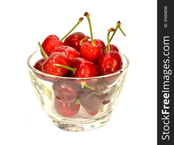 A glass bowl of cherries.