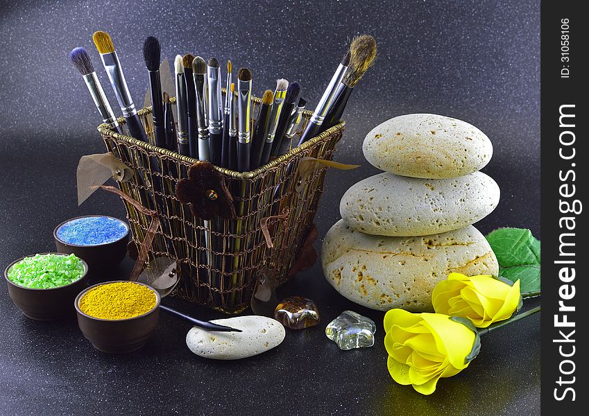 Composition of brushes with yellow roses on black background. Composition of brushes with yellow roses on black background