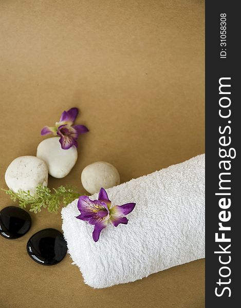 Orchid On Towel With Brown Background