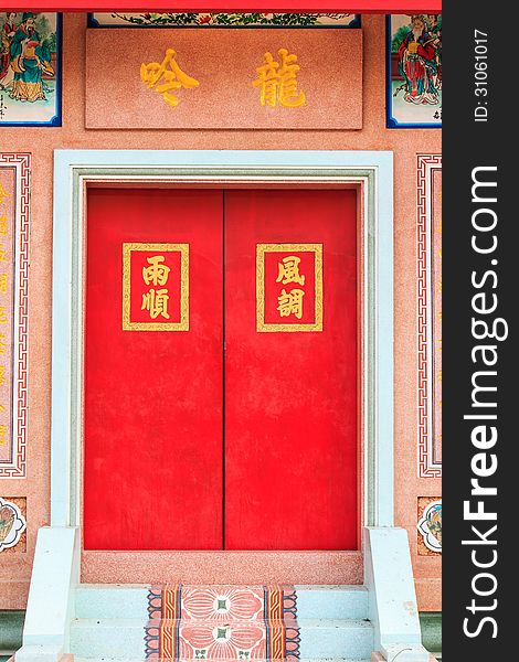 Red door of chinese temple in Thailand.