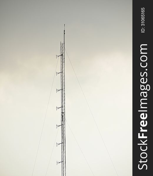 Pole of high antenna in cloudy sky. Pole of high antenna in cloudy sky