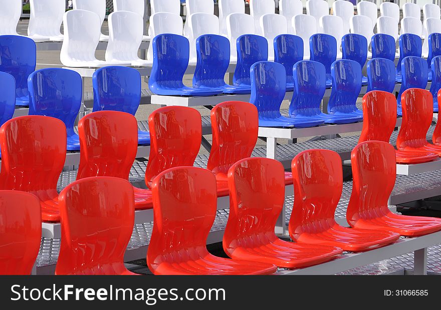 Stock Photo - bright chairs at the stadium. Stock Photo - bright chairs at the stadium.