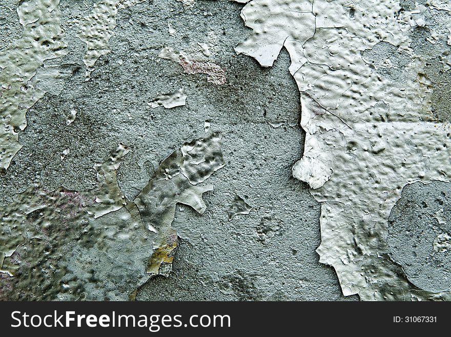 Grunge graffiti texture with closeup detail of old discoloured weathered paint peeling off a cement wall