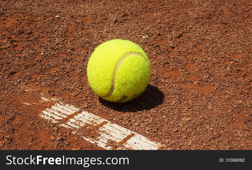 Tennis ball on the red clay