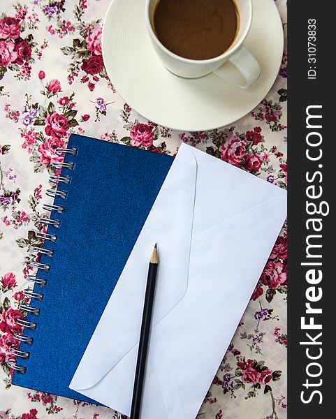 Blank envelopes on the table with pencil and coffee cup and blue