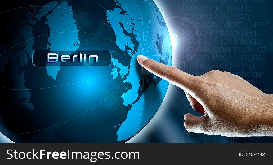 A woman finger point Berlin city on the world map. A woman finger point Berlin city on the world map