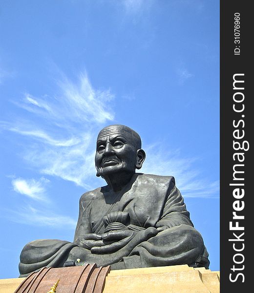 The Statue in temple on background sky. The Statue in temple on background sky