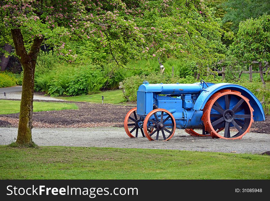 Old blue and orange tractor on display on farm