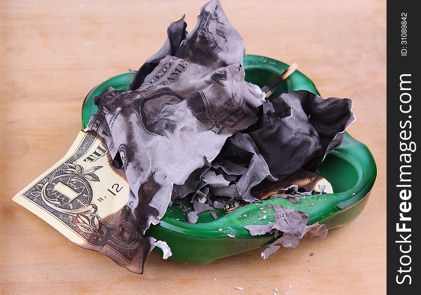 Burning dollar bill as a symbol of inflation and the financial crisis