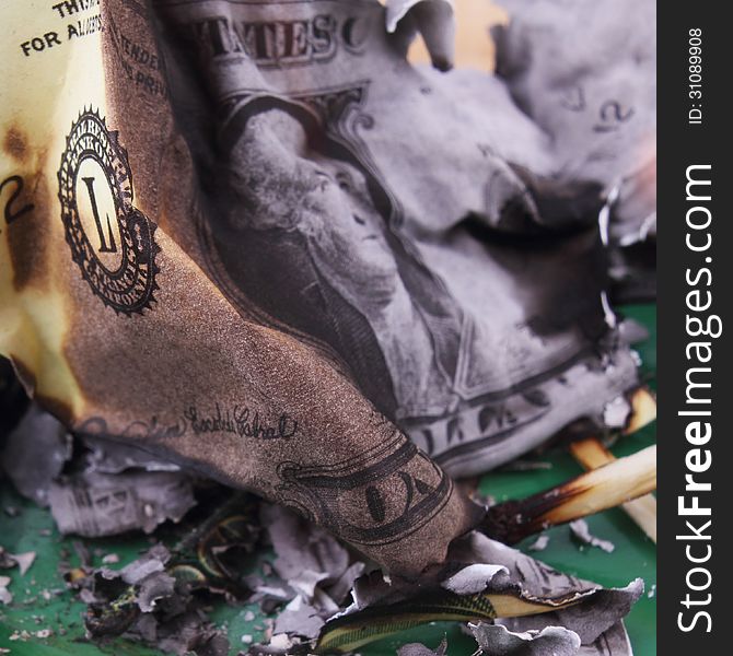 Burning dollar bill as a symbol of inflation and the financial crisis